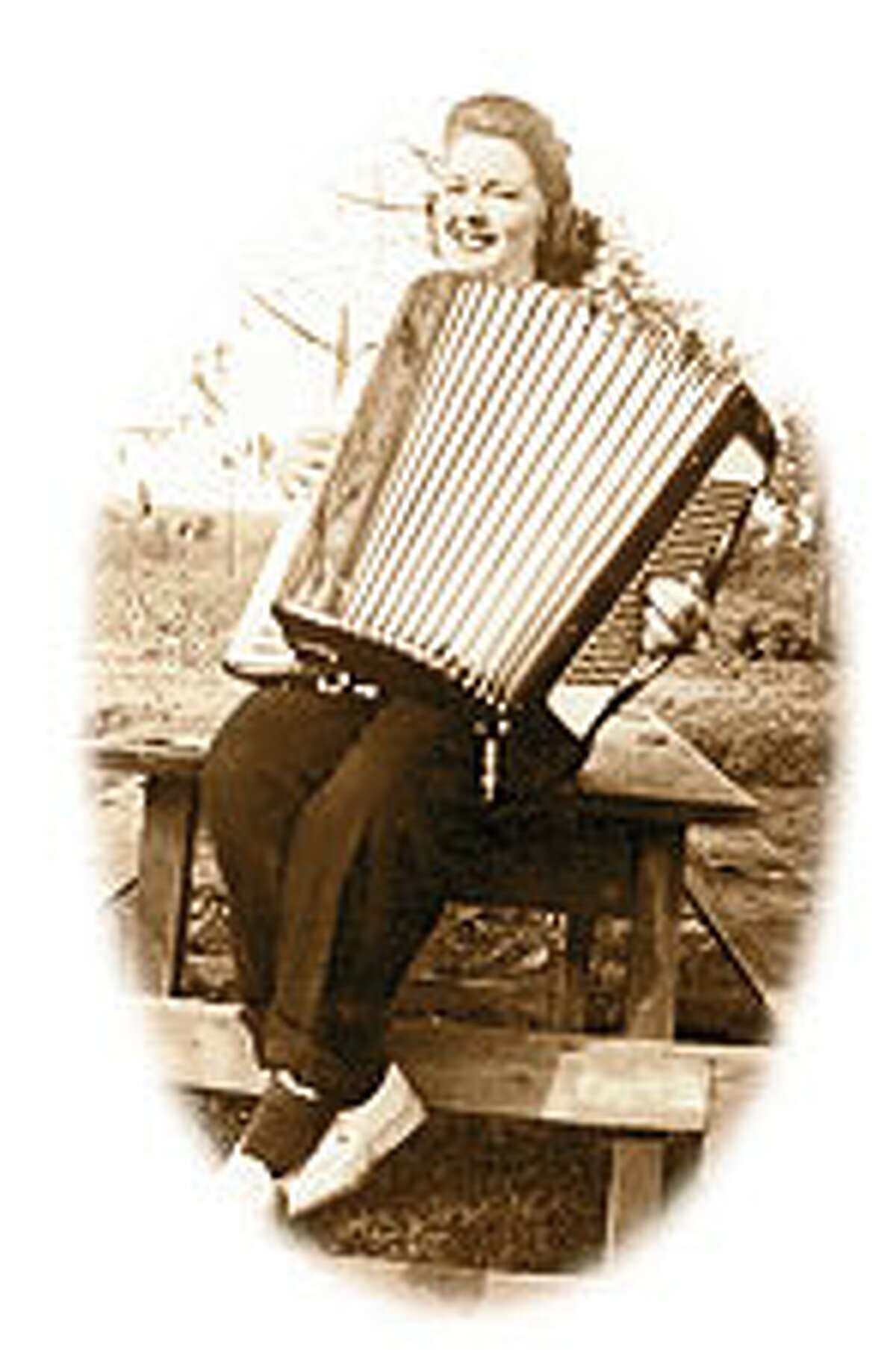 Around 1943 Sissel Almaas Peterson plays her accordion when musical get-togethers were popular.