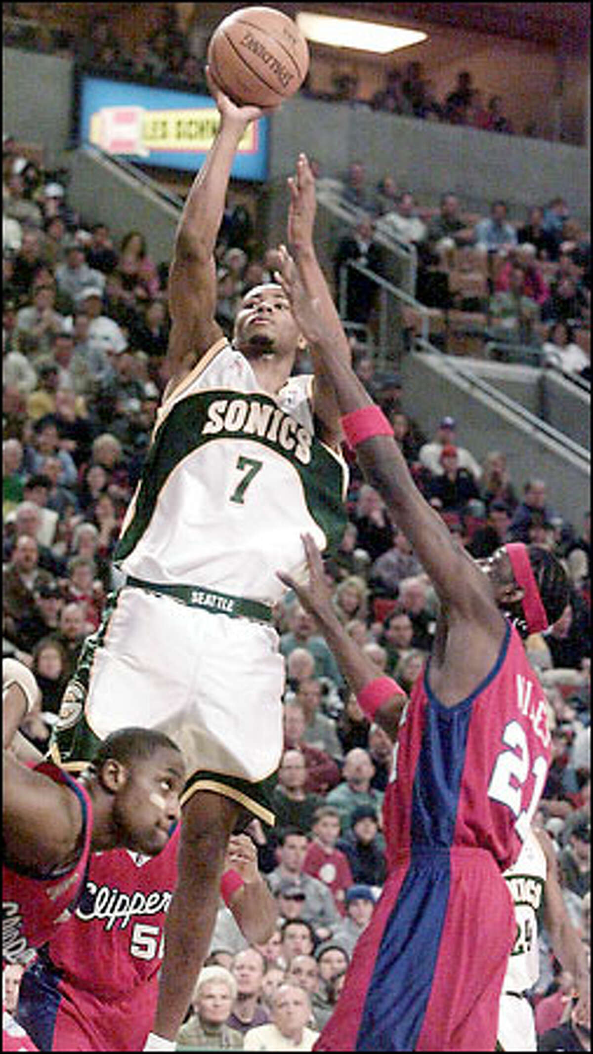 Sonics forward Rashard Lewis rises for a shot over the Clippers' Darius Miles. Lewis is shooting 46.4 percent from the field.