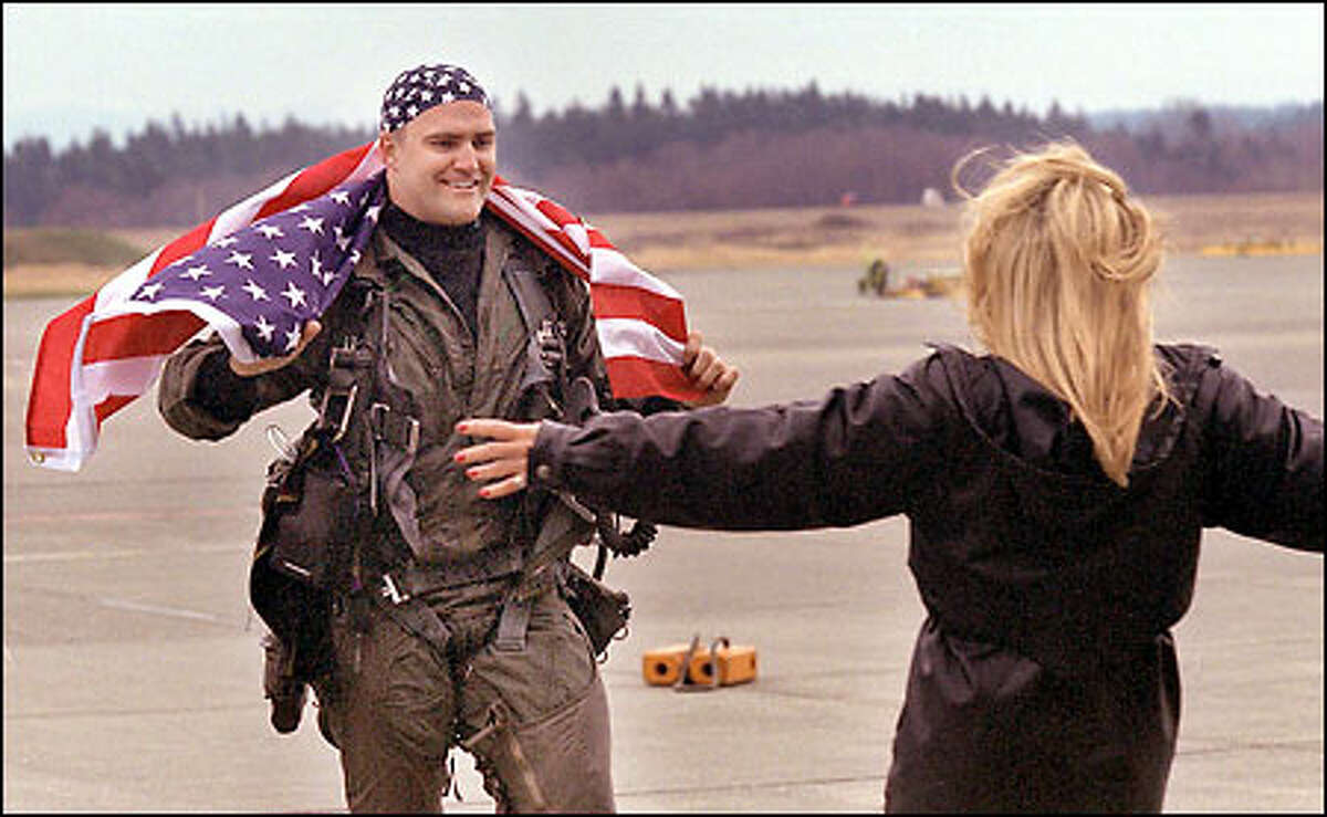 Navy pilot Lt. Mathew Kaslik greets his girlfriend on his return to Whidbey Island yesterday after six months at sea aboard the aircraft carrier USS Carl Vinson.