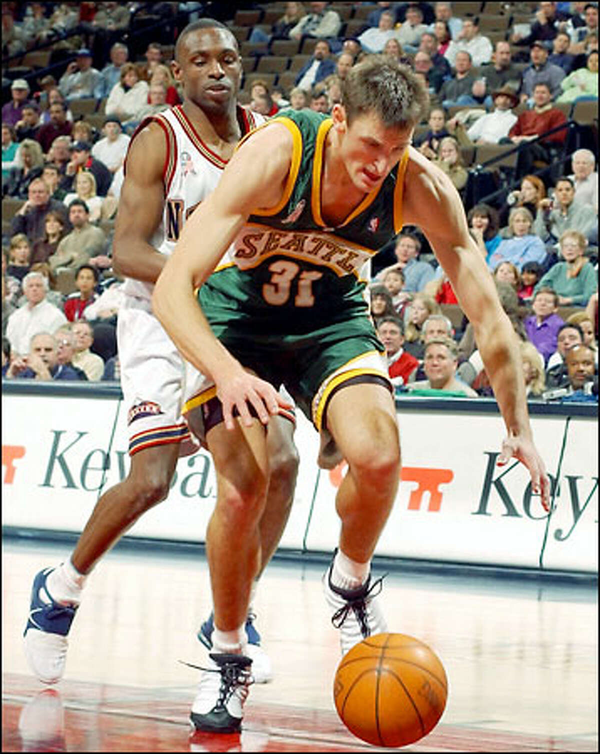 Sonics guard Brent Barry runs after a loose ball as Denver's Avery Johnson gives chase. Barry had nine points, seven rebounds and seven assists.