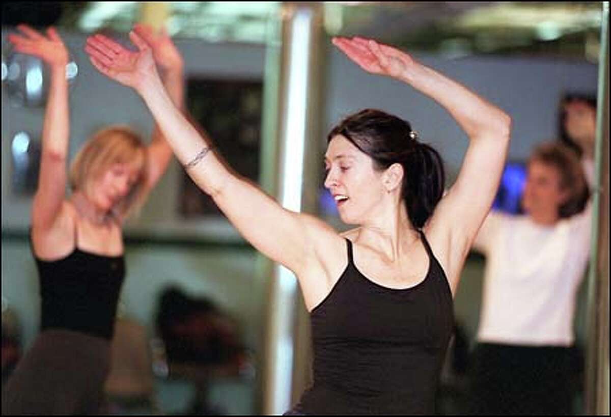 Christine Foro moves with the rhythm in a Nia workout at Paradise Dance Studio in Ballard. A form of no-impact aerobics, Nia is both structured and loose.