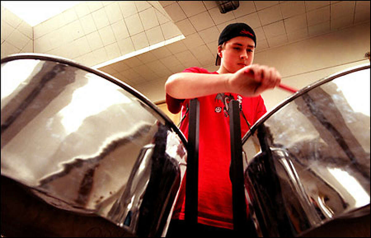 Taj Scott-Kelly jams on the steel drums during practice at Summit K-12 school in North Seattle. The drums appeal to a diverse group of students.
