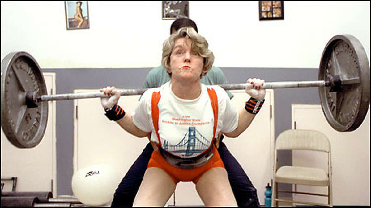 State Supreme Court Justice Faith Ireland, a powerlifter who will compete in the women's nationals next month in Chicago, concentrates during a workout with trainer Paula Houston.