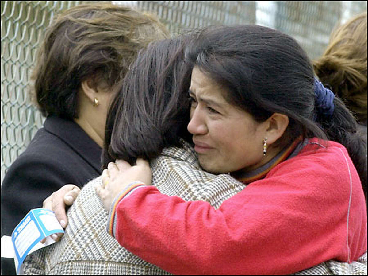 Relatives and loved ones of those who died when an Ecuadorean airliner crashed comfort each other yesterday at the airport in Tulcan, Ecuador.