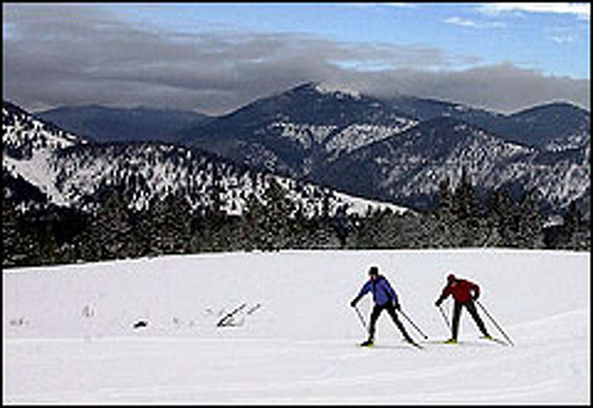 The mountains of the Continental Divide are a majestic backdrop for skiers at Alice Creek Ranch.