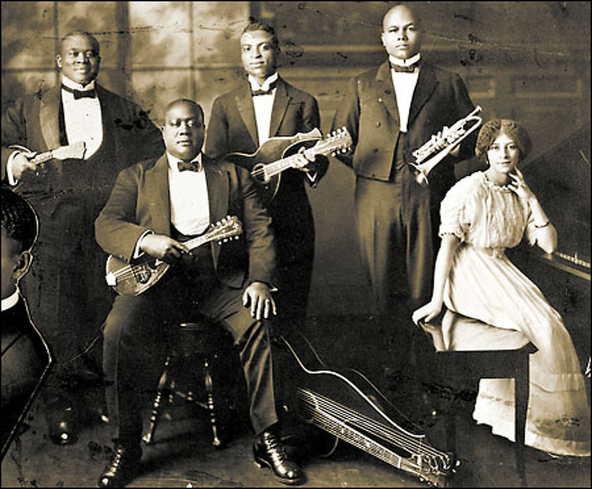 Seattle's thriving black music scene in the first part of the 20th century was a vital part of the city's cultural life. Frank Waldron, standing next to Coty Jones at the piano, was one of the most important figures in early Seattle jazz and influenced local musicians for 50 years. Waldron is shown with a trumpet as part of the Wang Doodle Orchestra, circa 1915, but he was better known as a saxophonist.