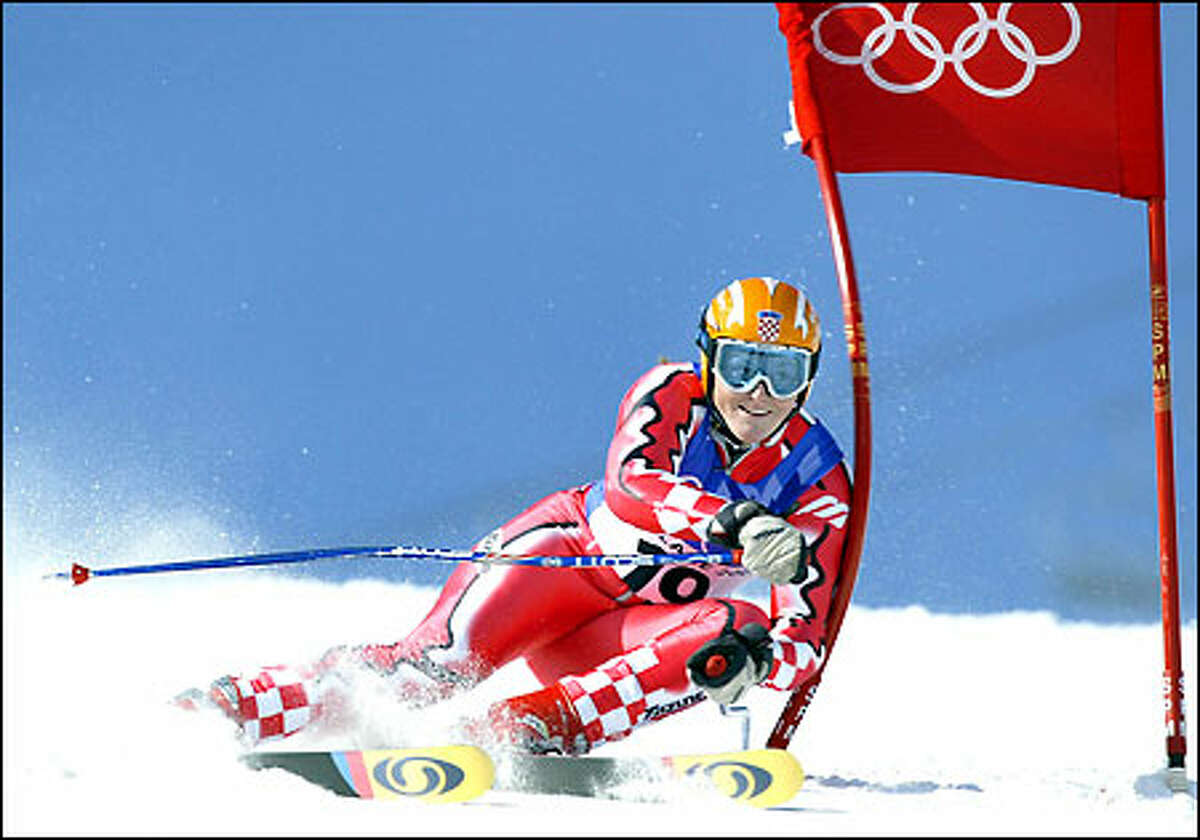Janica Kostelic of Croatia smacks a gate during the women's giant slalom in Park City, Utah. Kostelic blew away the field for her fourth medal of the Games.