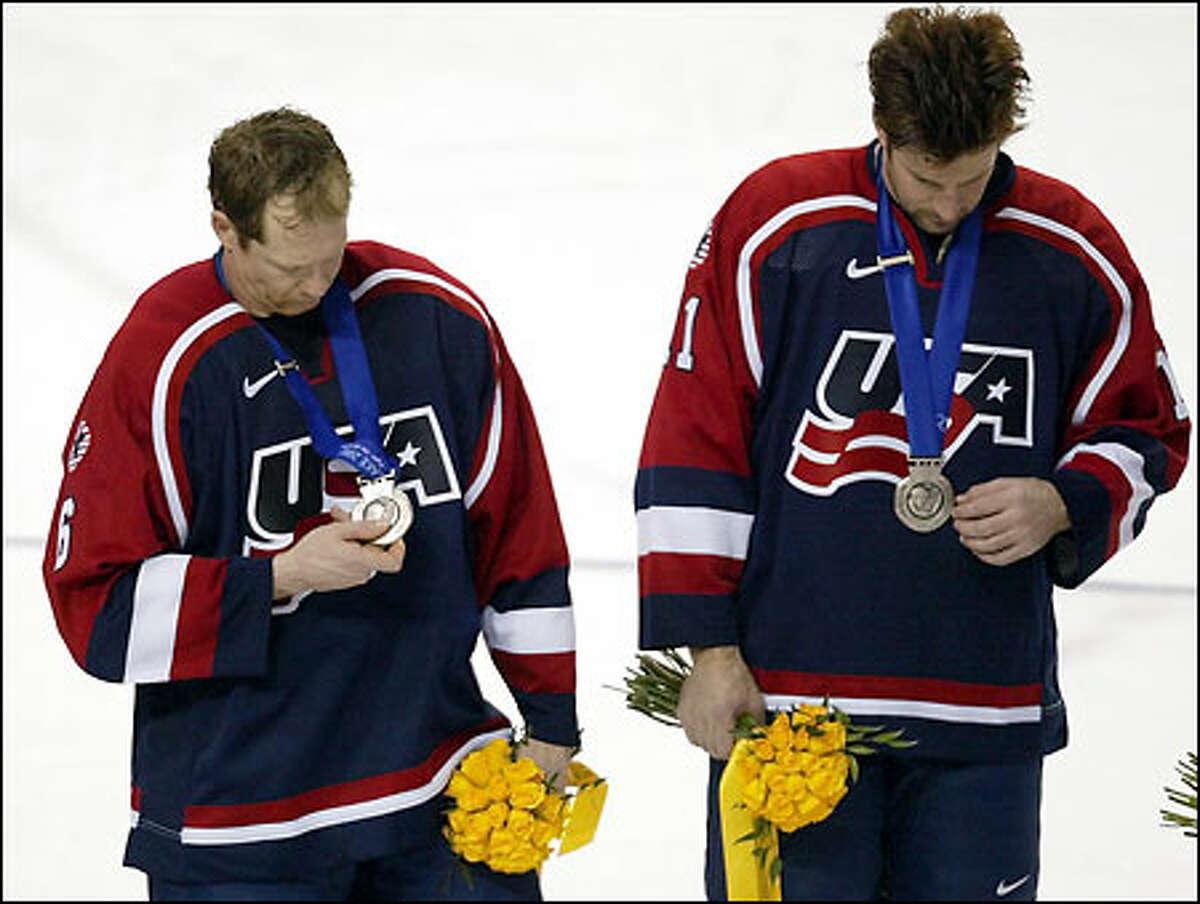 Americans Phil Housley (left) and Tony Amonte inspect their silver medals.