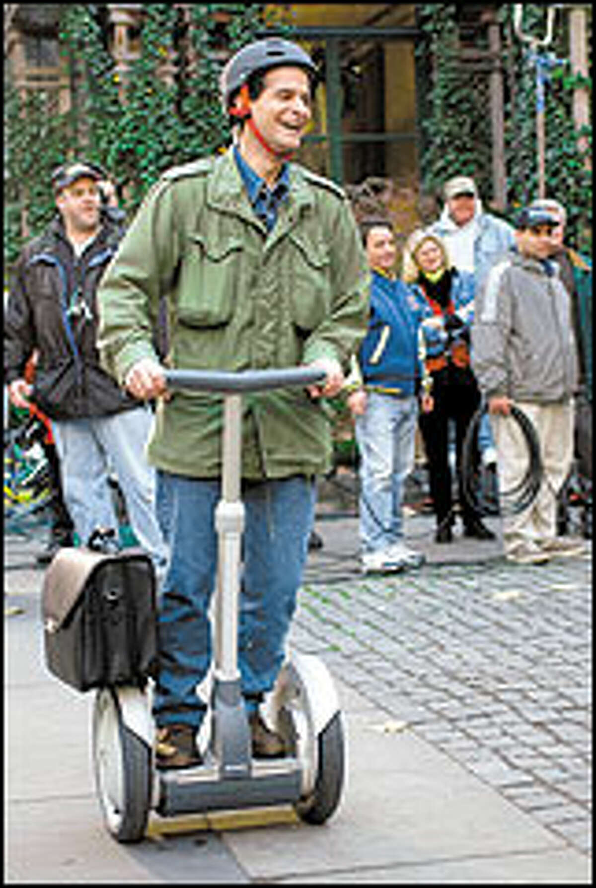 Inventor Dean Kamen shows off his Segway scooter, which goes 10 mph.