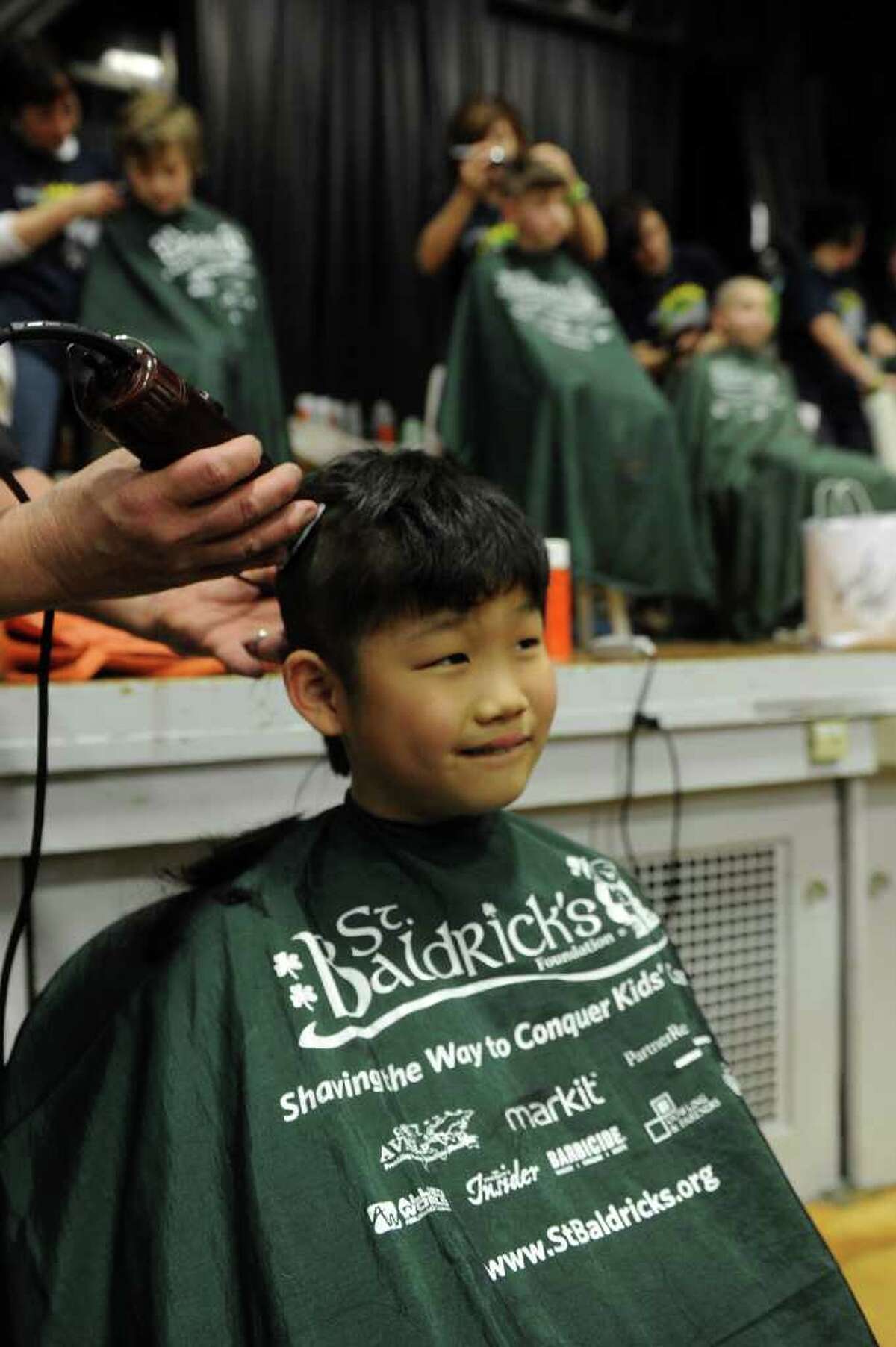 Jae Leighton, 9, gets his hair saved during Friday's St. Baldrick's fundraiser for children with cancer on March 11, 2011.