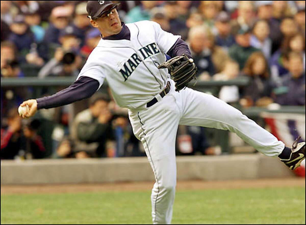 Mariners third baseman Jeff Cirillo picks up Kenny Lofton's bunt and makes an off-balance throw to get the out at first base in the fifth inning.