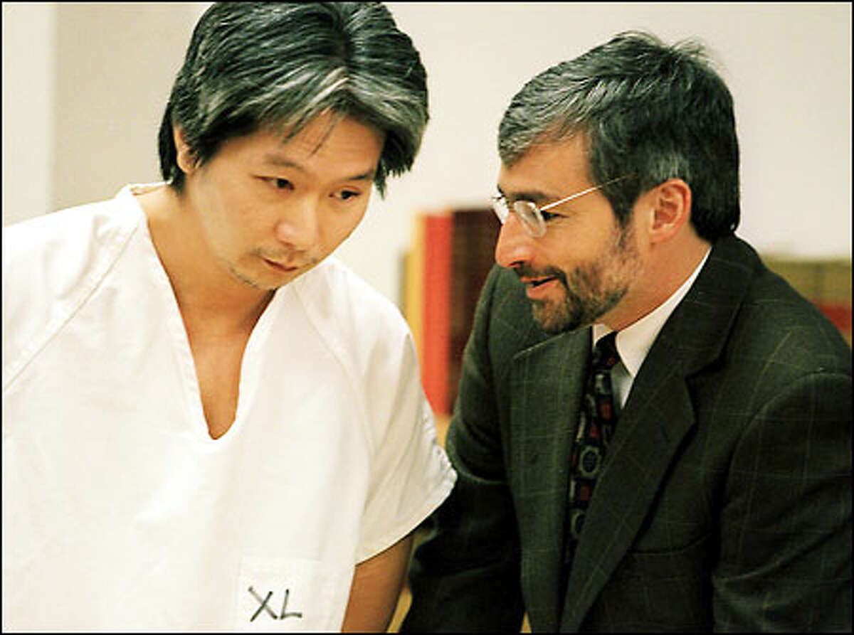 Kwan Fai Willie Mak, left, speaks with one of his attorneys, David Zuckerman, right, in court. Mak will be sentenced May 20 in the Wah Mee case.