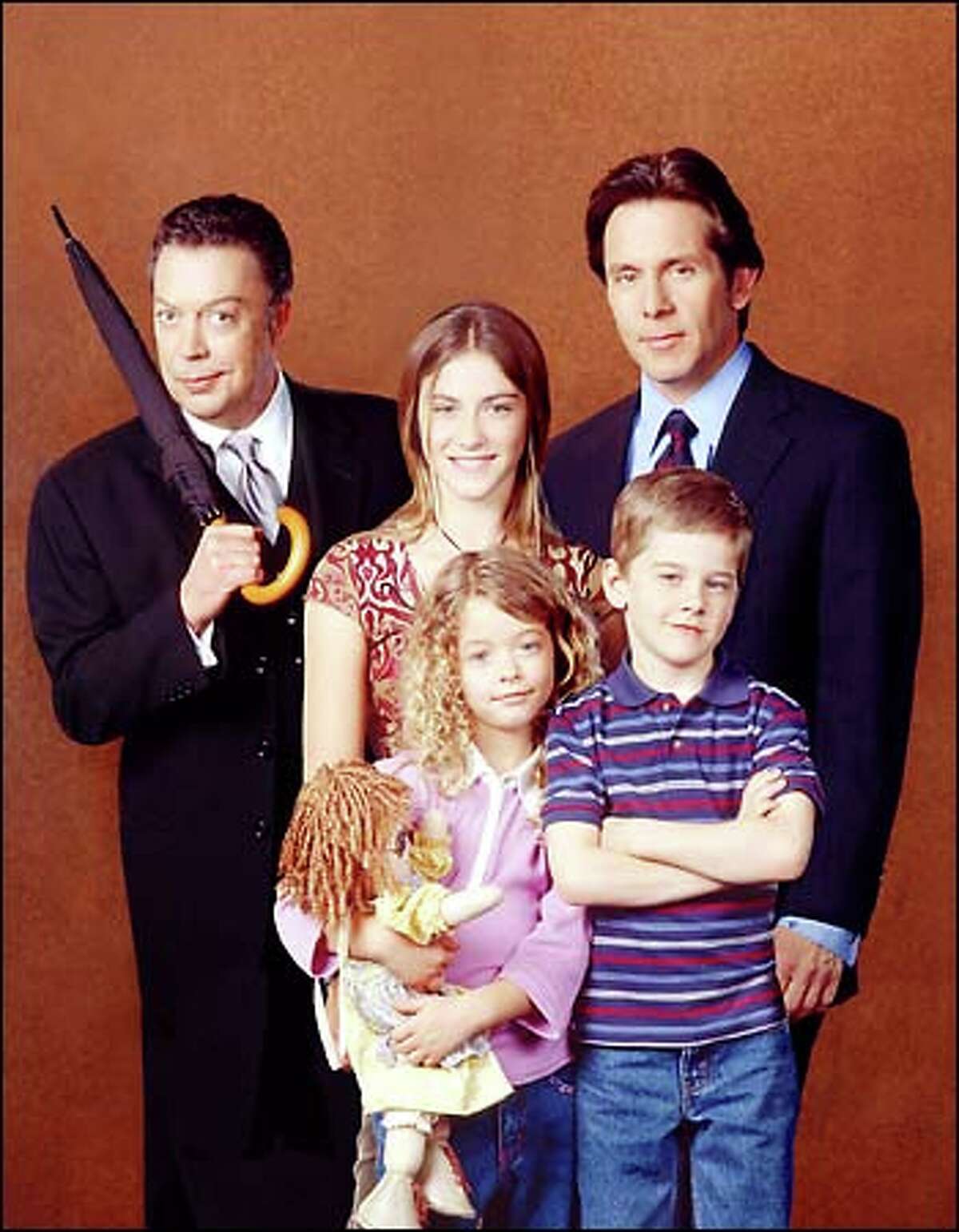 Tim Curry (rear, left) is Mr. French and Gary Cole (rear, right) is Uncle Bill in The WB's remake of "Family Affair"; also starring (front, left to right) Sasha Pieterse as Buffy, Luke Benward as Jody and Caitlin Wachs (rear, center) as Sissy.