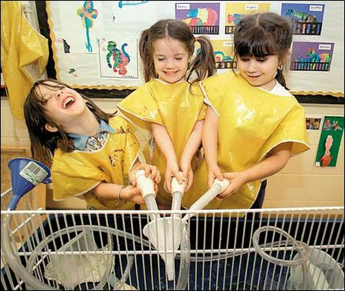 Brittany Kittelson, 5, Alexandria Dowd, 5, and Daisy Baez, 4, are learning about water and gravity in Head Start at Broadview-Thomson Elementary School.