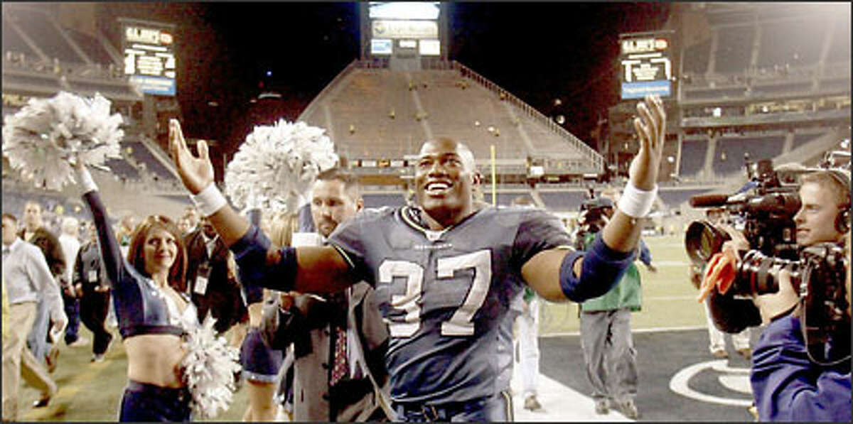 Shaun Alexander works the crowd at Seahawks Stadium after his five-touchdown, 139-yard rushing performance against the Vikings.