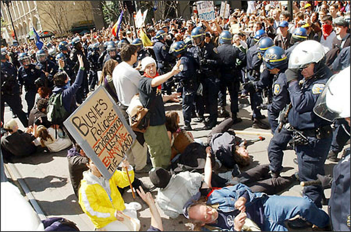 Protesters square off with police during an anti-war march in dowtown San Francisco yesterday. About 150 people were arrested on the third straight day of protests.
