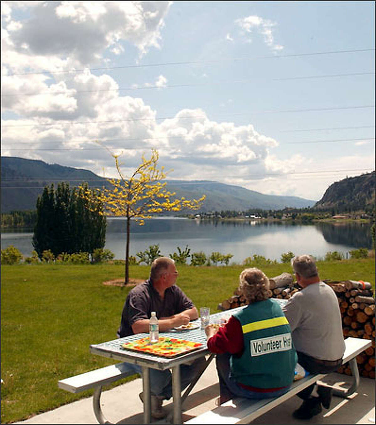 Camp hosts Ken and Karen Bauer, right, and Karen's brother, Ed Wendt, all from Wenatchee, survey the sunny scene at Daroga State Park.