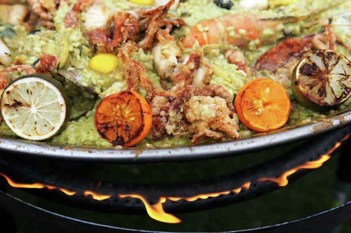 Grand Hyatt chef Jeffrey Axell's Thai green curry paella with rangpur limes, quail eggs, sea urchin, soft-shell crab and tiger prawns simmers over the flame at the 2011 Paella Challenge.