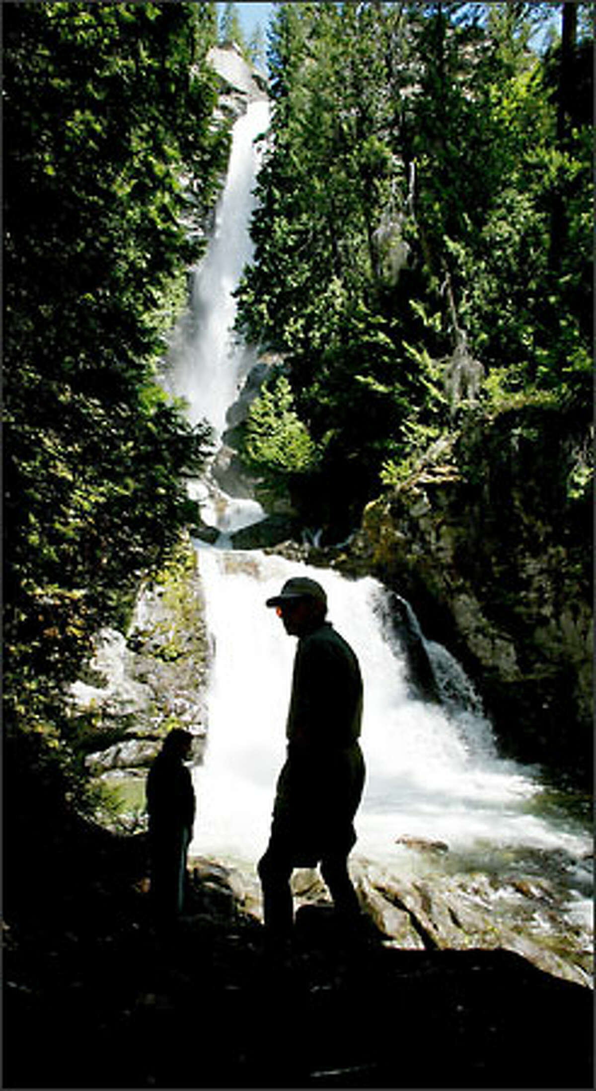 Rainbow Falls (Stehekin): The 312-foot-high waterfall, in the Lake Chelan National Recreation Area,  is a scenic gem of the Stehekin Valley, at the head of Lake Chelan.  It an be reached by taking a National Park Service bus up valley, or by renting a bicycle. Rainbow Falls  can be enjoyed from a picnic area by the road, or by a short trail that climbs up stairs to the left.  The falls is framed in Ponderosa pines.  The remote valley is a wonderful place to camp out and hang out for a few days, away from the 24/7 news cycle and the internet. Be thankful of citizens in the 1960's who worked to create the North Cascades National Park complex.