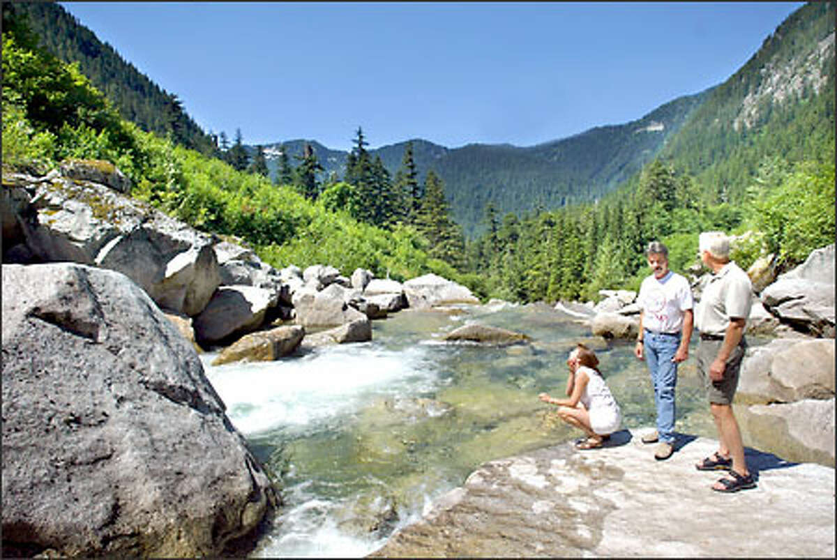 From left to right: Dawna Finley, Mike Finley and Ed Husmann, all from Index,WA, visit a recreational area on the north fork of the Skykomish River in the Mt. Baker Snoqualmie National Forest which people will no longer be able to access if the proposed Wild Sky Wilderness Area designation passes. Their group, Forests for People, is fighting this proposal because the wilderness designation will tear out or close roads and bridges people currently use to access remote areas. "This is a place where you can go and find nobody...... even on weekends." says Mike Finley. The Finley's own and operate A River's Edge Country Cottage Bed and Breakfast out of Index,WA.