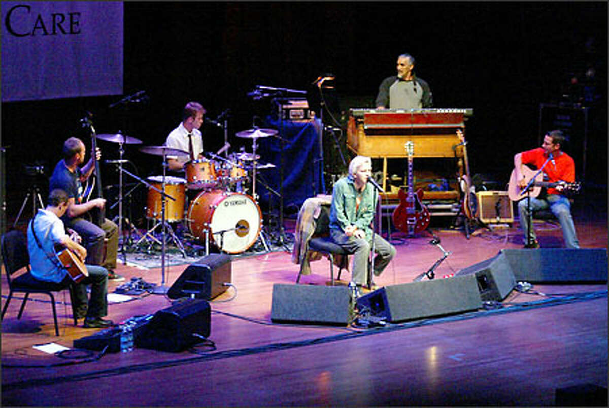 Eddie Vedder, center; Mike McCready, lead guitar, far left; Jeff Ament, bass, left; Matt Cameron, drums; Boom Gaspar, organ; and guitarist Stone Gossard, far right, during Pearl Jam's benefit concert Wednesday at Benaroya Hall in Seattle.