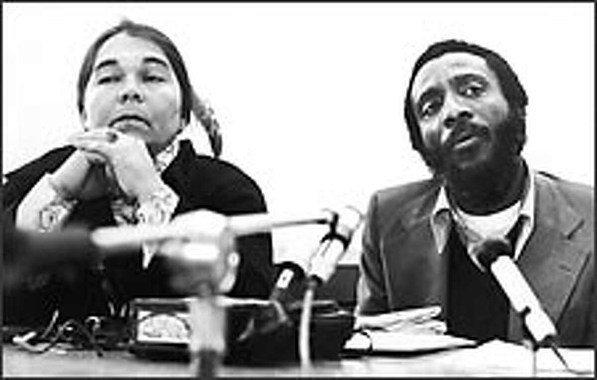 At a 1976 news conference, Janet McCloud and rights activist Dick Gregory call for an investigation at the Pine Ridge Indian Reservation.