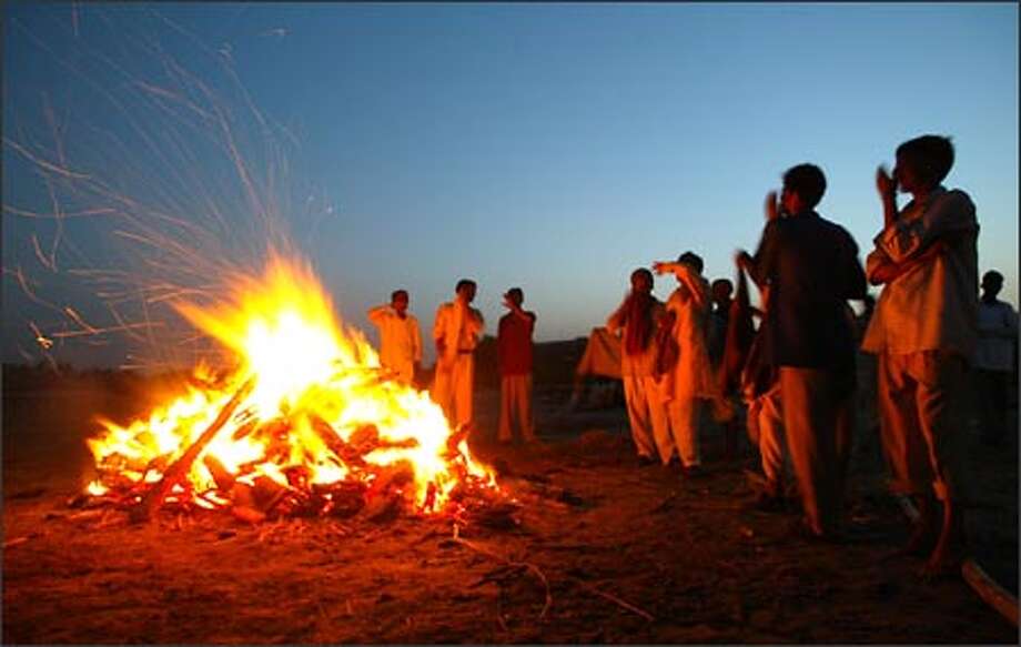 indians burning the funeral pyre on the river ganges indians burning the funeral pyre on the river ganges