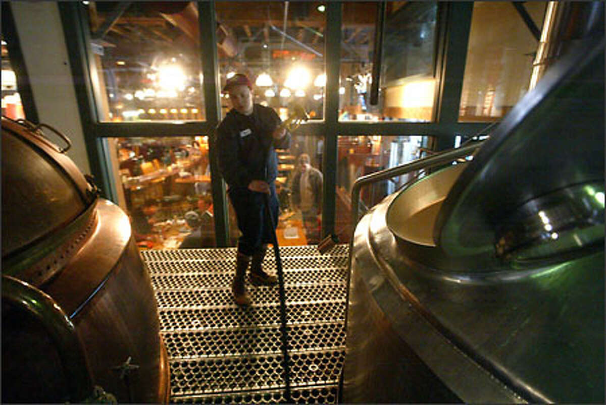 Brewer Tom Bradford of Seattle's Pyramid finishes a batch of beer. The acquisition of Portland Brewing Co. will increase Pyramid's market clout.