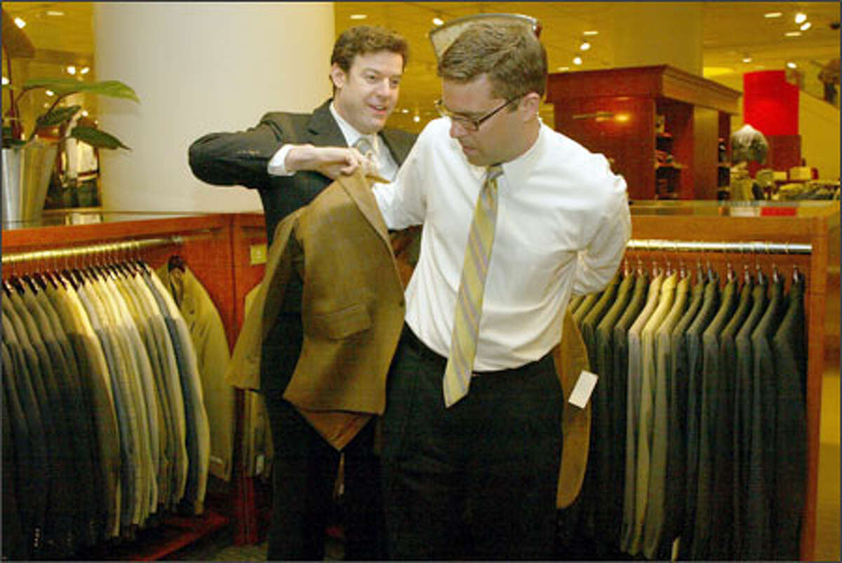 Brett Blake, left, shows Clay Nielsen a sport coat at the downtown Seattle Nordstrom. Nielsen has bought from Blake for about nine years.