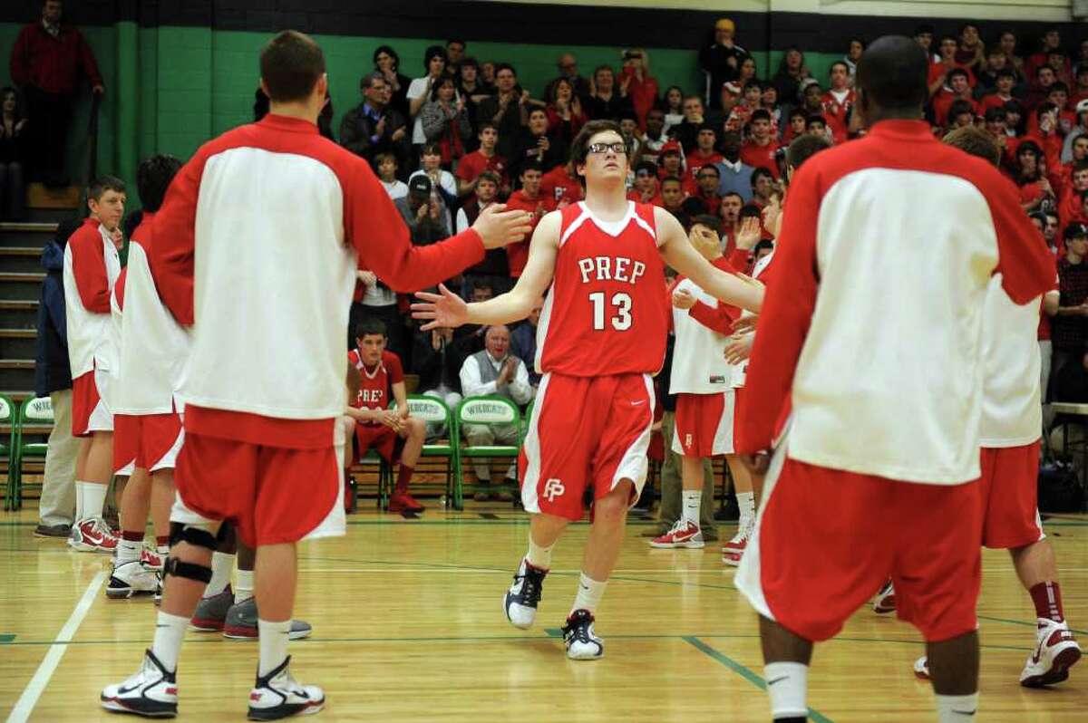 Fairfield Prep's Kevin Potter is welcomed to the court during Tuesday's class LL semifinal game at Wilby High School in Waterbury on March 15, 2011.