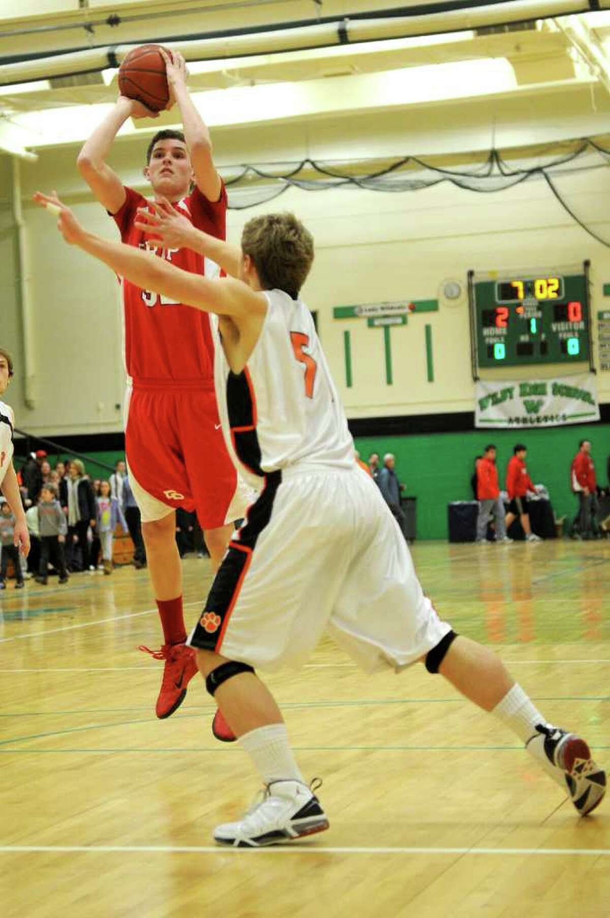 Fairfield Prep's Matt Daley takes a shot as Ridgefield's Mike Kenny defends during Tuesday's class LL semifinal game at Wilby High School in Waterbury on March 15, 2011.