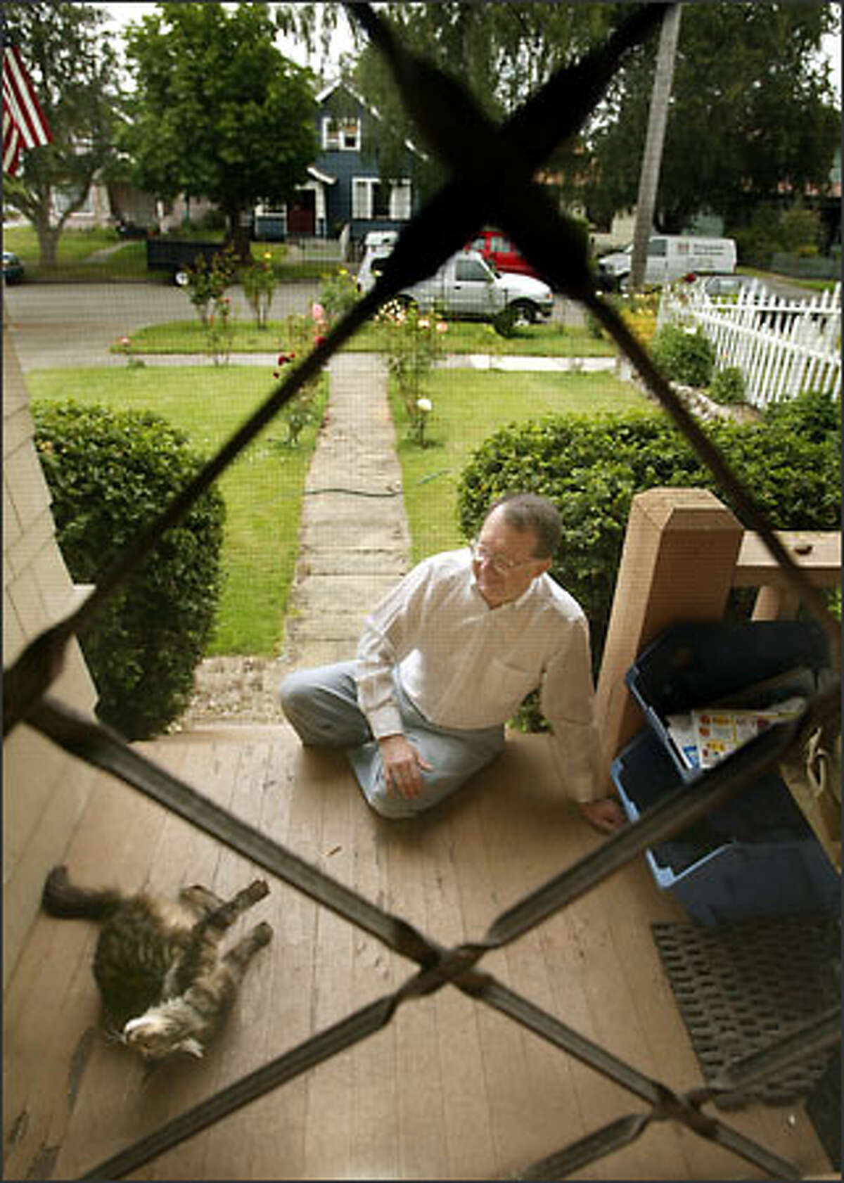 James Gaylord and his cat Katya on the porch of his North End Tacoma home. Gaylord was fired from his teaching job in 1972 when an assistant principal came to his house and asked Gaylord if he was gay. Gaylord said "yes."