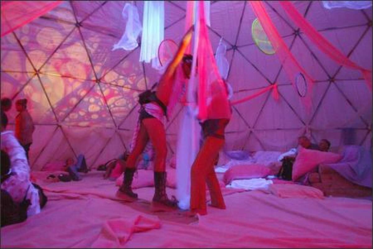 Here Deringer Rambleforth III of Seattle has a brief dance with Gary Culp inside the "Space Virgin" dome, a place where festival-goers can take off their shoes and relax out of the sun and wind at the Burning Man Festival at Black Rock, Nev.