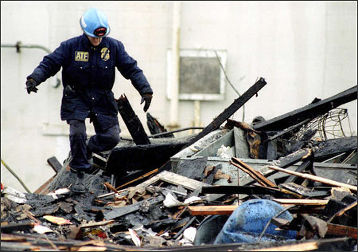 An investigator searches the Mary Pang's Food Products plant after the 1995 fire. Martin Pang, son of the building's owner, was convicted of arson.