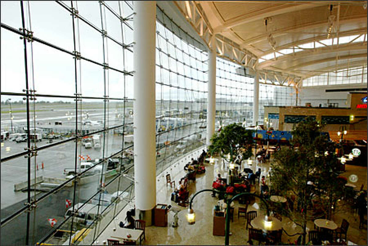The Central Terminal's 60-by-350-foot glass wall offers a spectacular view of the activity on Sea-Tac Airport runways. The panes compose a compound curve, convex in the vertical plane and concave in the horizontal.