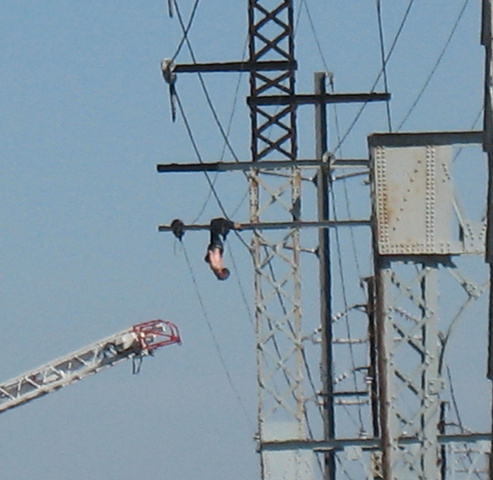 Man rescued from rail power lines