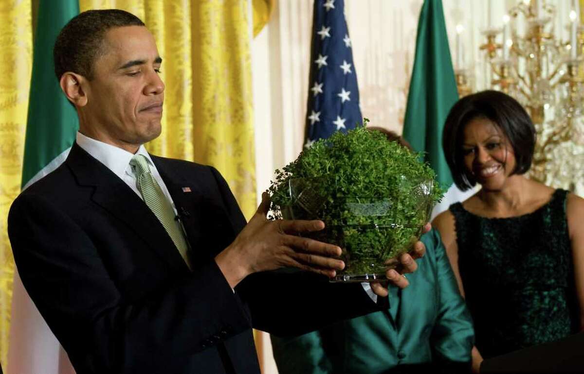 It's an annual St. Patrick's Day tradition for the prime minister of Ireland to present the president of the United States with a potted clover. Here, President Barack Obama holds a bowl of shamrocks presented to him by Prime Minister Brian Cowen, alongside First Lady Michelle Obama (R) during a St Patrick's Day reception in the East Room of the White House in Washington, DC, March 17, 2010.