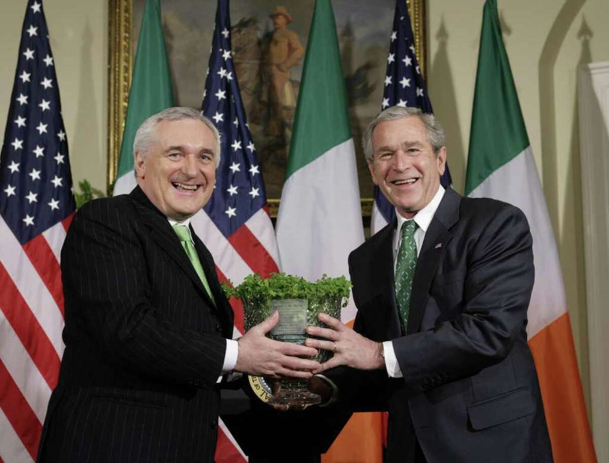 President George W. Bush, right, accepts a ceremonial bowl of shamrocks from Irish Prime Minister Bertie Ahern during a St. Patrick's Day ceremony at the White House in March 16, 2007.