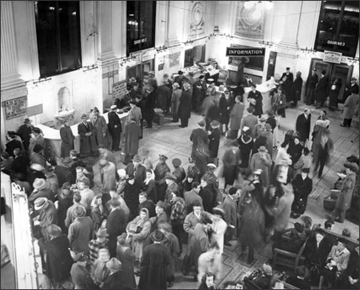 In this 1949 file photo, when train travel was a popular mode of transportation, a crowd waits in King Street Station for the departure of the Empire Builder.