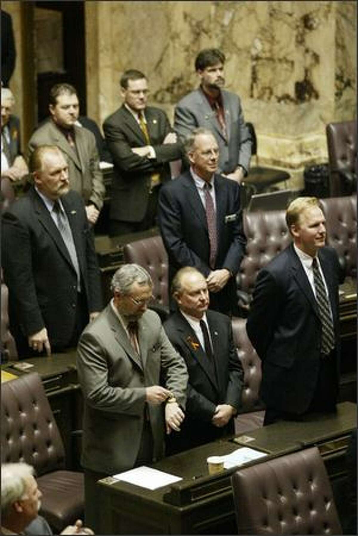 Republican members of the House and Senate, one looking at his watch, refused to applaud Christine Gregoire after she was sworn in as governor.