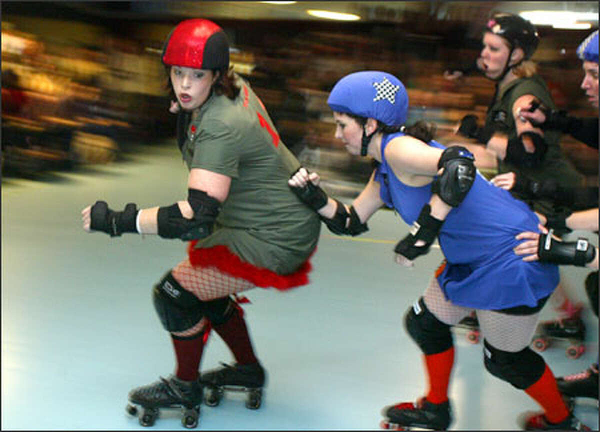 Skaters from the Derby Liberation Front in green and red compete against the Sockit Wenches in blue. The teams take each other on once a month.
