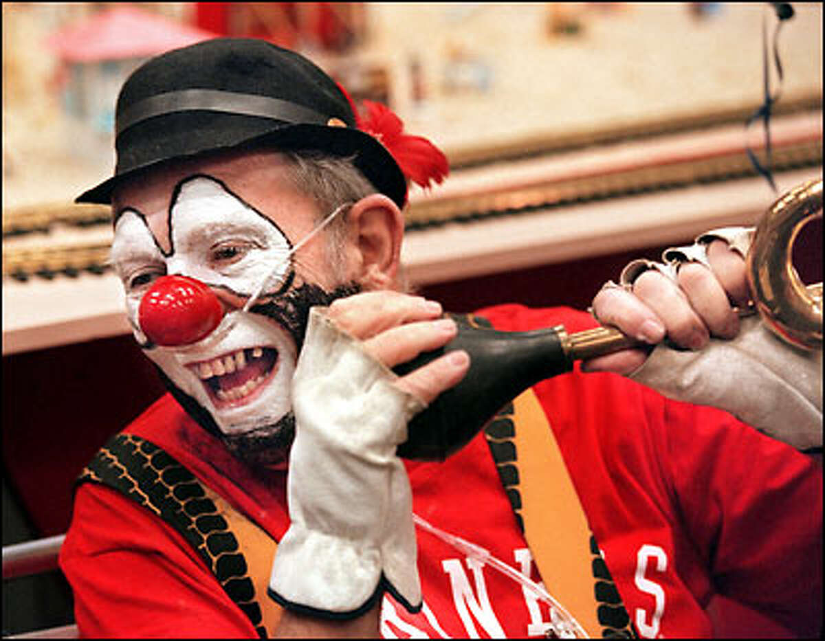 Patrick Kine, 65, of Olympia, also known as "Red Nose" the clown, wears an oxygen line as he toots his horn at a convention in June in Boise, Idaho. Kine, who suffered from mesothelioma from working with asbestos in brakes, died in August.