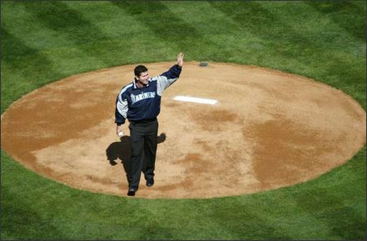 Former Mariner Edgar Martinez waves to adoring fans before throwing out the first pitch during opening day festivities at Safeco Field.