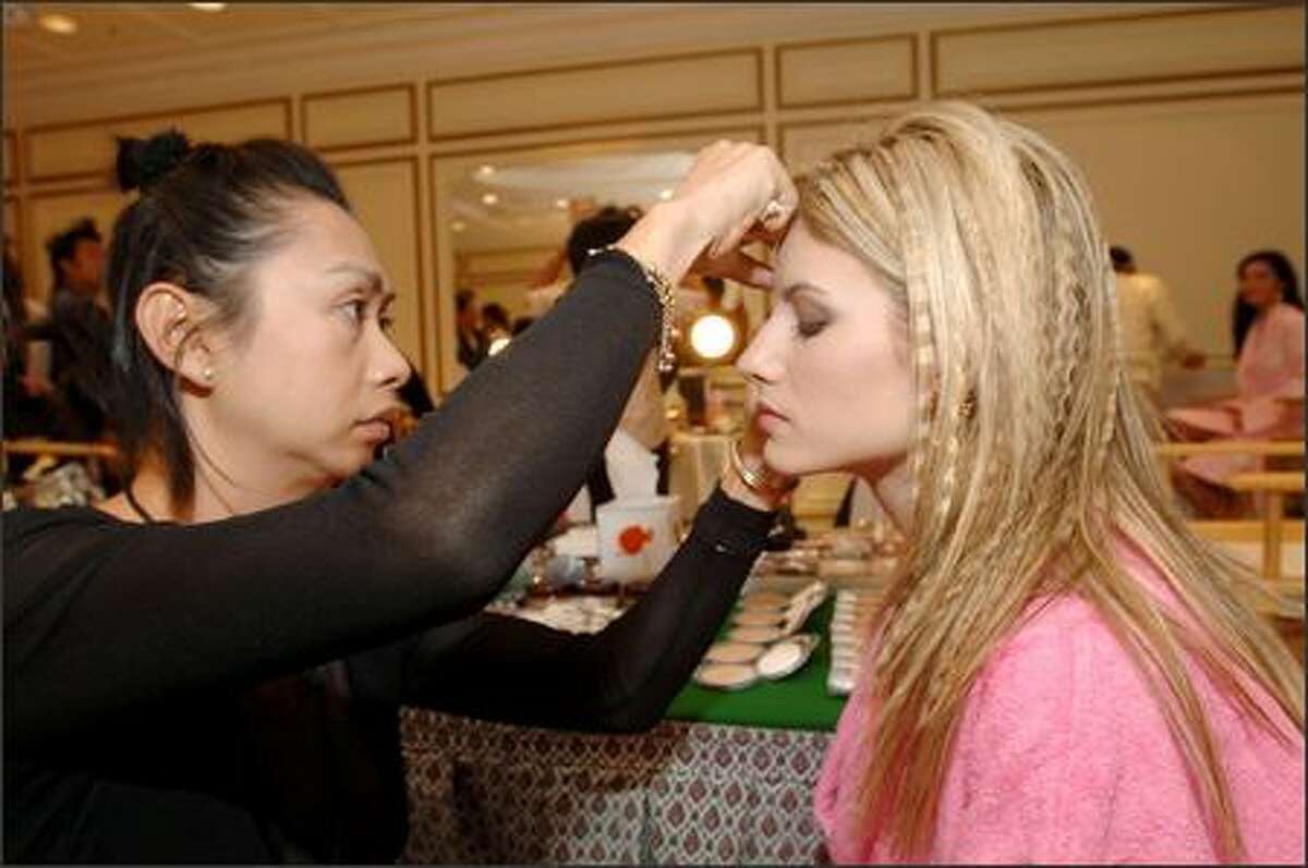 Makeup artist Sitporn "Daeng" Phujaroen applies CoverGirl cosmetics to Evangelia Aravani, Miss Greece, during registration and fittings for the 2005 Miss Universe competition at the Dusit Thani Hotel in Bangkok, Thailand on May 8. The pageant comes to an end May 30 with a live telecast on NBC (tape-delayed in the Pacific time zone).