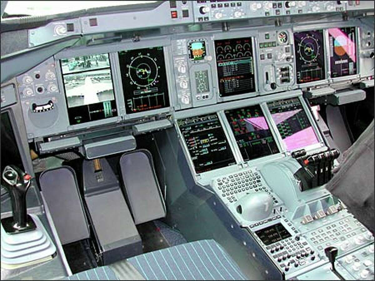 Here's the cockpit of the A380. At left is the joy stick, which in all Airbus planes replaces the more traditional yoke. On screen in front of the pilot's position are views from some of the 35 on-board cameras on the plane. The top view is the scene underneath the aircraft. The bottom view is from a camera mounted on the plane's vertical tail.