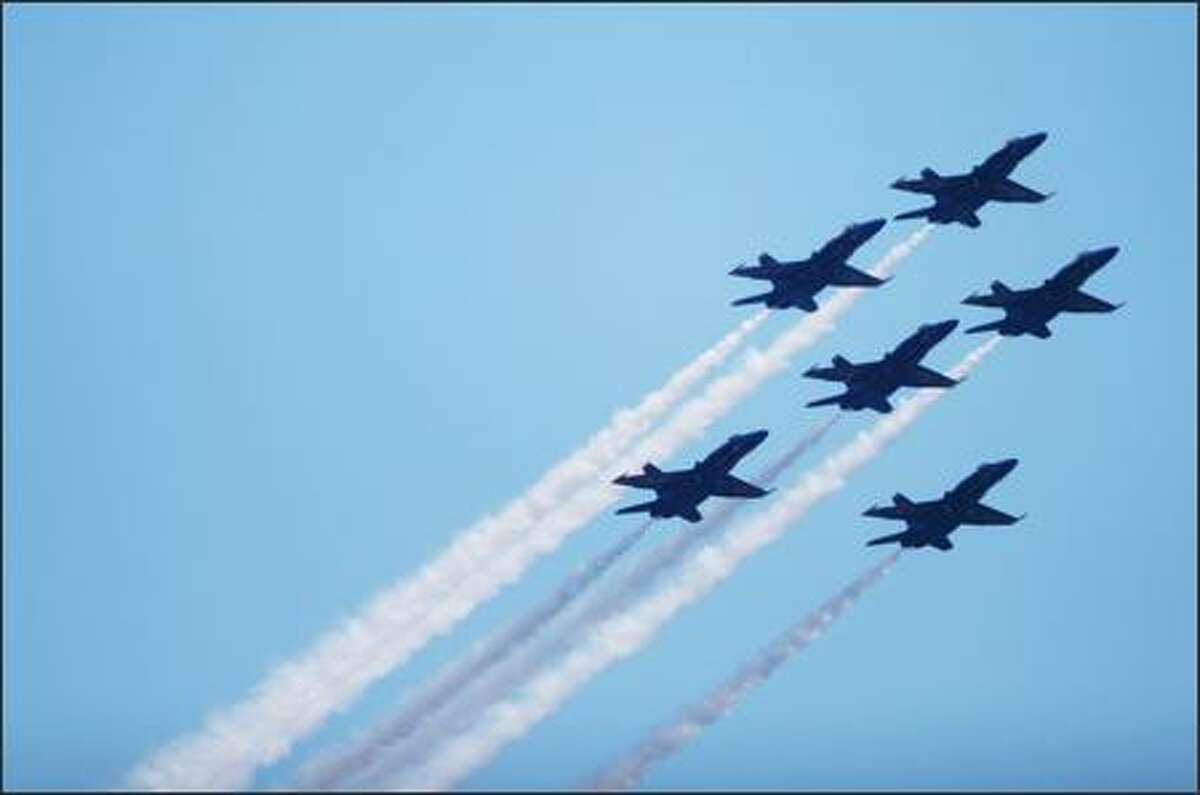 The Navy's Blue Angels fly in formation at the start of the Seafair Airshow over Lake Washington Saturday.