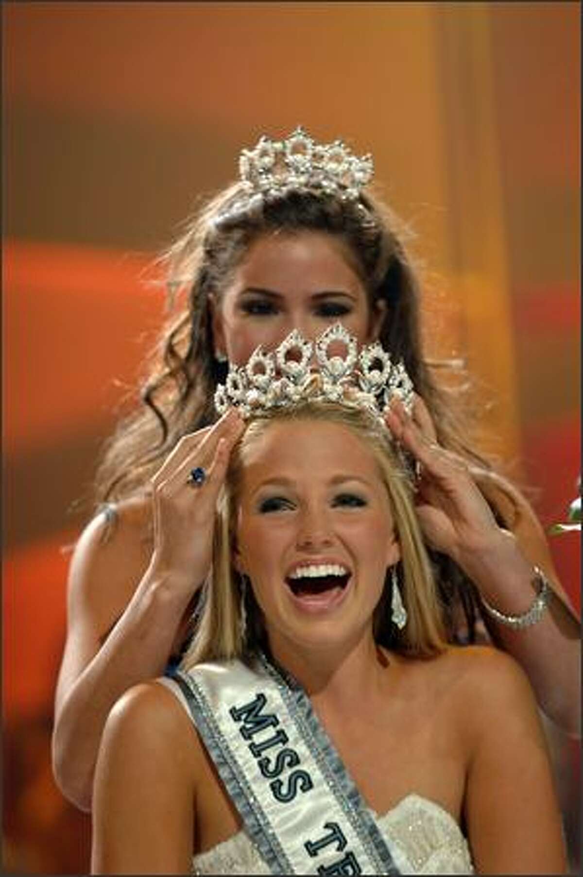 Allie LaForce reacts while being crowned Miss Teen USA 2005 by Shelley Hennig, Miss Teen USA 2004.