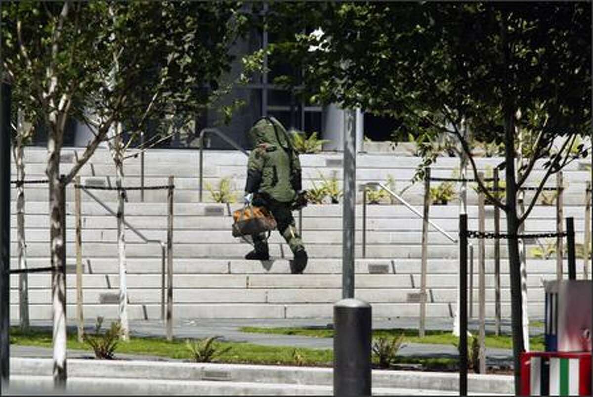 A bomb expert enters the federal courthouse in Seattle after a Seattle police officer shot and killed a man with a grenade.
