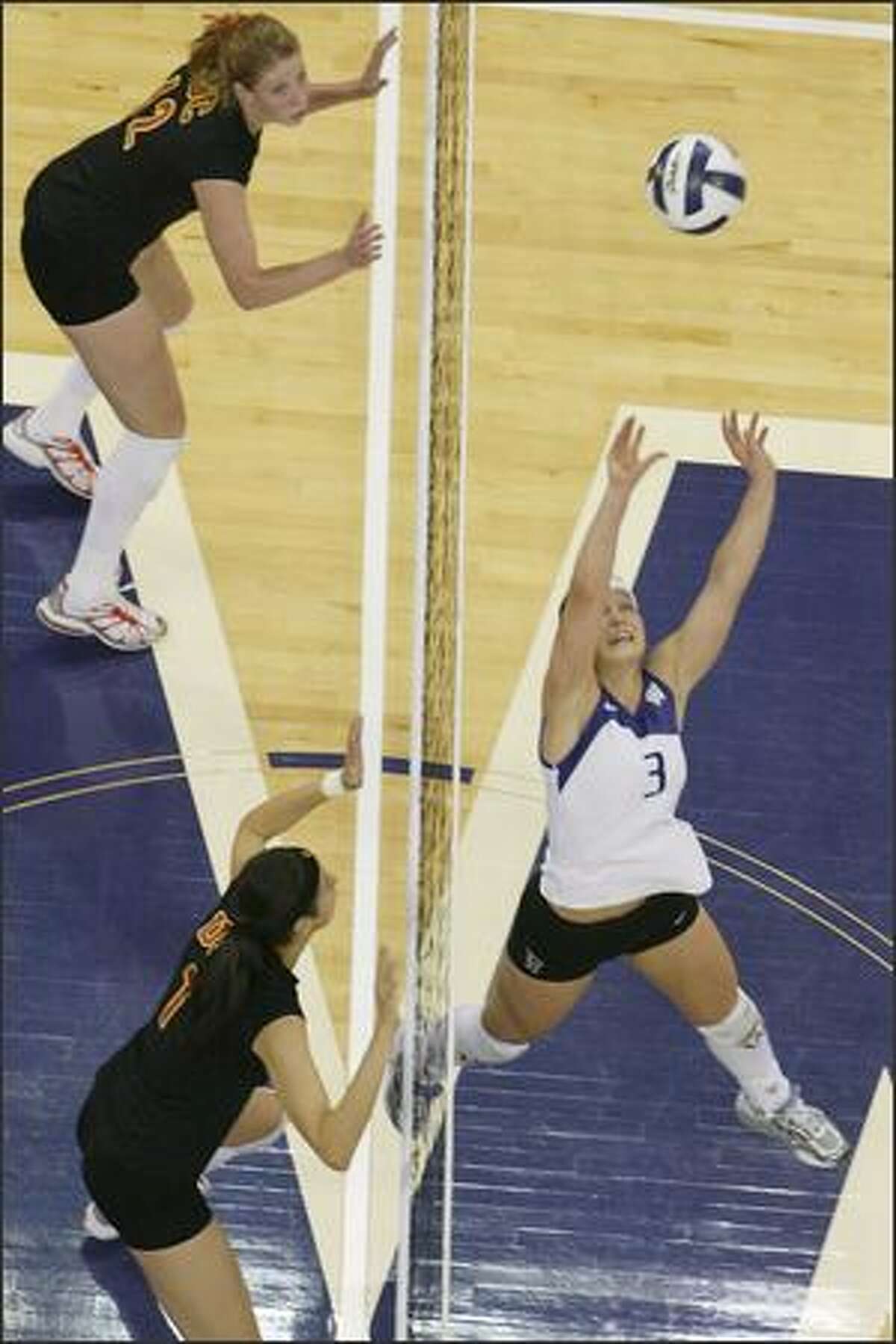 Courtney Thompson sets the ball for a kill during UW's win against USC in Seattle. Thompson earned first-team All-American honors last year after ranking third nationally with 14.67 assists per game.