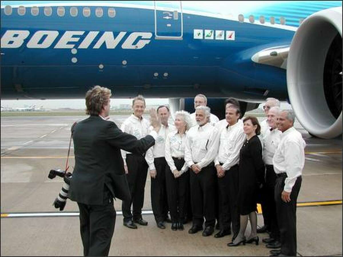 The Worldliner's flight crew poses for a group photo after landing at London's Heathrow Airport following a record-making, 22-hour-and-42-minute, nonstop flight from Hong Kong.